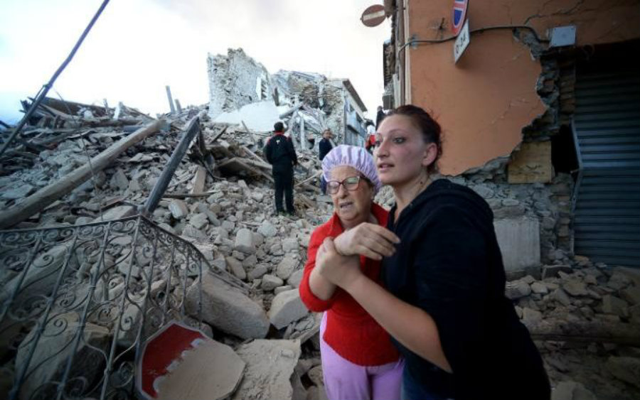 Residents react to the latest earthquake to hit Italy. Mother and daughter watch in terror how most buildings collapsed. Image Credit: Telegraph