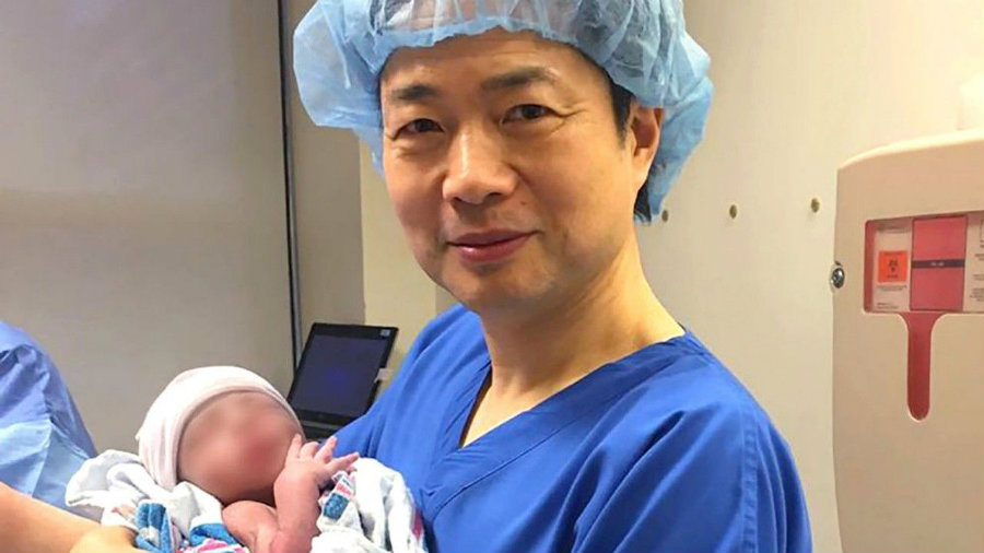 Dr. Zhang holds the first baby born with the "3-parent" technique.. Photo credit: New Hope Fertility Center / Wiat.com